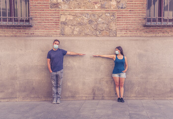 Obraz na płótnie Canvas Man and woman keeping social distancing. Coronavirus COVID-19 protection