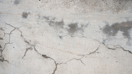 Old aged grunge damaged weathered gray grey concrete cement wall texture background banner panorama, with cracks