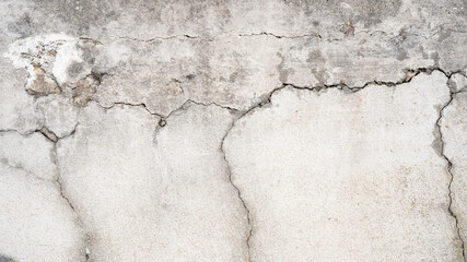 Old aged grunge damaged weathered gray grey concrete cement wall texture background banner panorama, with cracks