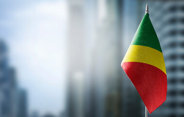 Fototapeta na wymiar A small flag of Congo on the background of a blurred background