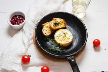 Delicious beautiful baked camembert with honey, walnuts, herbs and cranberries