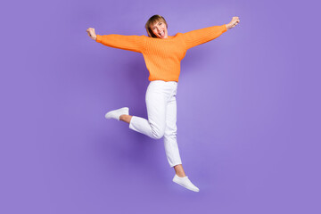 Fototapeta na wymiar Full length body size photo of jumping woman laughing childish careless isolated pastel violet color background