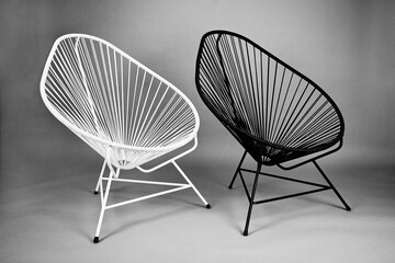 Two acapulco chairs in black and white