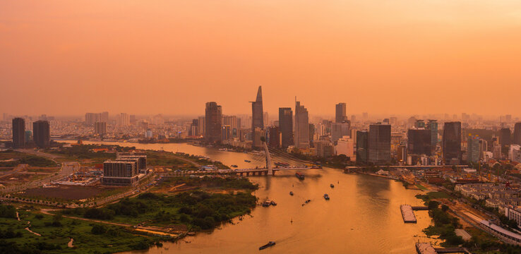 Aerial view of Ho Chi Minh city, Vietnam. Beauty skyscrapers along river light smooth down urban development. Dramatic lighting spectacular sunset.