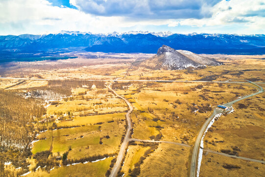 Lika region. Zir hill and Velebit mountain in Lika landscape aerial view. A1 highway.