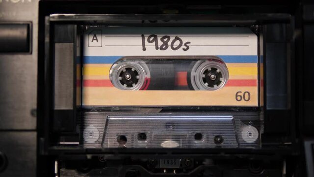 4K: Audio Cassette 1980s Tape playing in Recorder - Vintage Eighties or 80s retro music. Stock Video Clip Footage