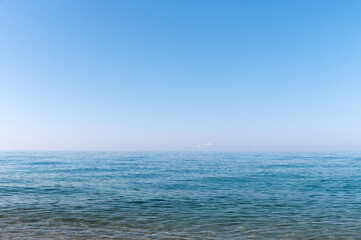 Fototapeta premium Calm morning sea. Small waves in calm conditions. Sea background