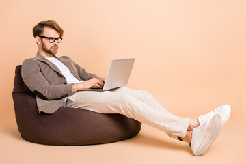 Full size photo of serious focused confident businessman working in laptop computer isolated on pastel color background