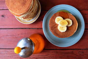 Breakfast oatmeal pancakes with banana, walnuts and honey. Traditional American Breakfast. The concept of home made healthy food.