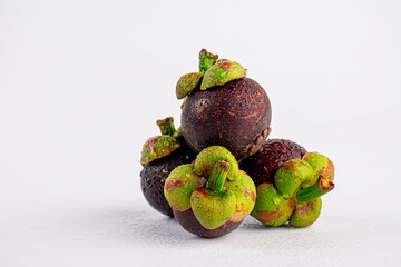 Mangosteen with water drops on white background 