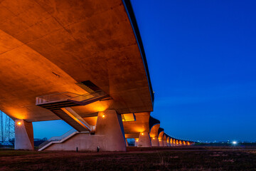 The De Oversteek bridge in the Dutch city of Nijmegen is illuminated in the evening.