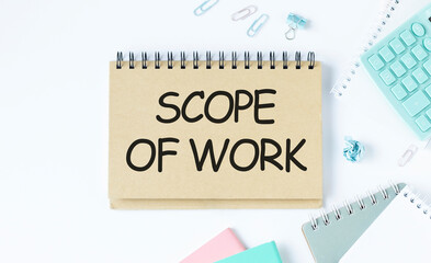 Scope of work. inscription on a white business card against the background of financial charts of a pencil and money. BUSINESS CONEPT