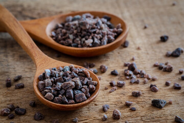 Himalayan black rock salt on wooden spoon