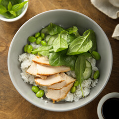 Healthy rice bowl with chicken and spinach