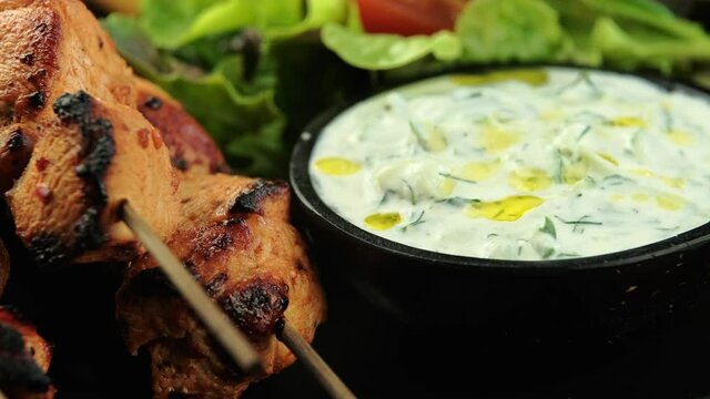 Chicken fillet souvlaki, bbq, kebabs on skewers with potato chips, salad and fresh home made tzatziki