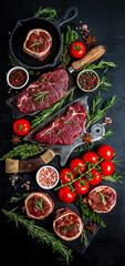 raw set beef steaks on over meat butcher knife with spices dark background. Close up vertical image, place for text