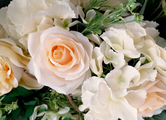 Beautiful bouquet of white roses from fabric close-up stock images. Floral decoration with plastic white roses top view stock photo. Beautiful flowers white roses made of plastic images