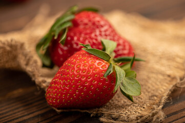 Fresh strawberries on a wooden table. Harvesting.