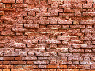 Fototapeta premium Horizontal part of a Venetian old red brick wall, background,