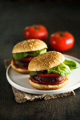 Homemade burgers with tomato and basil