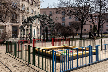 spring park in a residential area children's sandbox with toys, no children