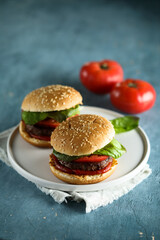 Homemade burgers with tomato and basil