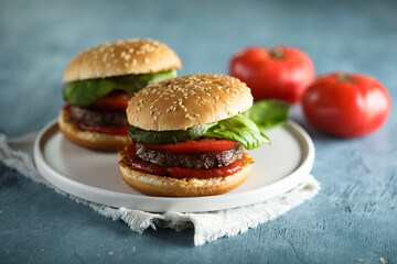 Homemade burgers with tomato and basil