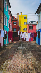 Laundry put to dry on a small traditional and very colorful place on the island of Burano