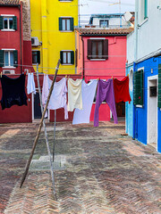 Fototapeta na wymiar Laundry put to dry on a small traditional and very colorful place on the island of Burano