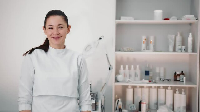 Portrait of a beautician in a beauty salon. Beautician looks at the camera.
