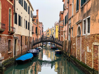Fototapeta na wymiar Unrecognizable person walking on a bridge in Venice, Italy