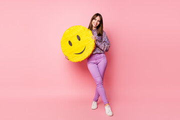 Full size photo of young good mood cheerful smiling girl hold big smile emoji icon isolate on pink color background