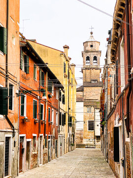 Colorful picture of a small street full of lines to hang the laundry in Venice, Italy. No boat, no people