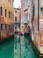 Beautiful water reflections in the small canal, Venice, Italy