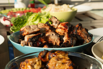 Picnic outside with barbeque meet and fresh vegetables in summer time