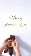 Happy Father's Day greeting card. Plush crochet teddy bear in a suit.