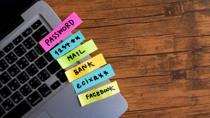 password, mail, bank, facebook, message concept written post it on laptop keyboard.	