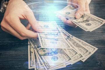 Double exposure of technology drawing hologram and us dollars bills and man hands. Data concept