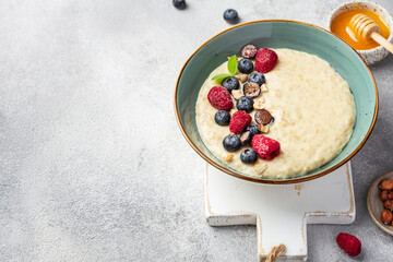 oatmeal with berries in bowl on white background