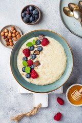 oatmeal with berries in bowl on white background