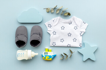 Baby accessories with bodysuit and shoes. Flat lay