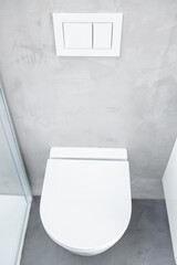 Wall mounted or suspended toilet or WC in home bathroom with push button flush