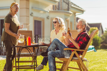 Senior friends having an outdoor lunch