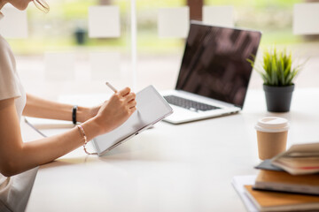 Businesswoman Hands Using digital tablet and laptop in office table.blank screen 