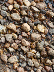 Photo of the texture of a stone path from stones laid out to the water, stone background, texture of a stone floor. The road is made of small and large stones.