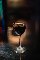 Manhattan cocktail decorated with lemon zest.