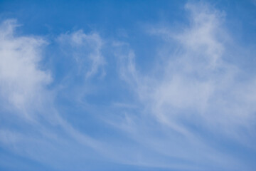Wispy cirrus clouds and a blue sky