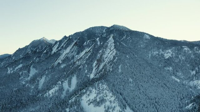 chautauqua flatiron mountains during the winter covered in snow from a drone