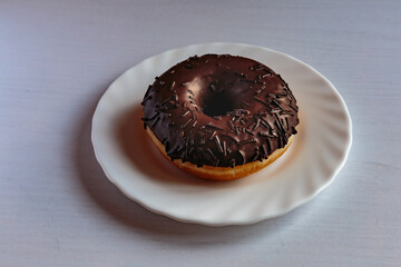 Tasty glazed chocolate donut with cream.