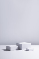 Fashion modern abstract showcase with set white square podiums in sunlight with shadow for...
